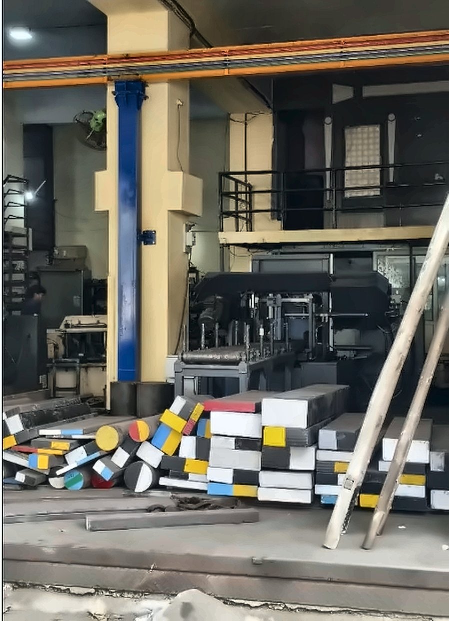 Bandsaw machine and stacked flats at Apeksha Alloys